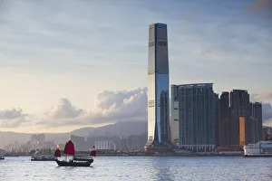 Junk boat passing International Commerce Centre (ICC), West Kowloon, Hong Kong Junk boat passing International Commerce Centre (ICC), West Kowloon, Hong Kong