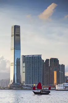 Junk boat passing International Commerce Centre (ICC), West Kowloon, Hong Kong