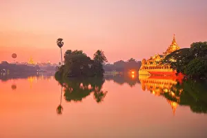 Ancient Monument Prints: The Karaweik Palace barge and the Shwedagon Pagoda reflected in the Kandawgyi Lake waters at twilight