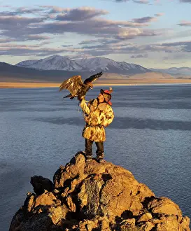 Clothing Prints: Kazakh Eagle Hunter with his Golden Eagle at sunset against a mountainous backdrop
