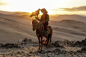 Attire Prints: Kazakh Eagle at sunset on horseback with his trained golden eagle