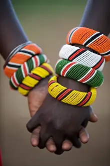 C Ulture Prints: Kenya, Laikipia, Ol Malo. A Samburu boy and girl hold hands at a dance in their local manyatta