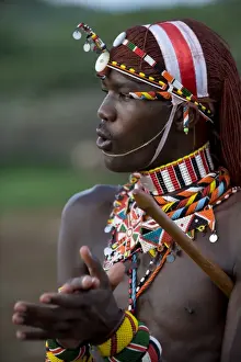 Head Dress Prints: Kenya, Laikipia, Ol Malo. A Samburu warrior sings and claps during a dance