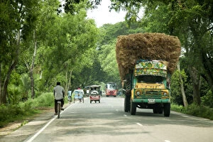 Images Dated 7th April 2016: Khulna, Bangladesh. Loaded trucks bring crops from the countryside to the centre of