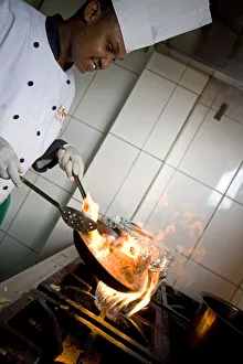 Rwanda Gallery: Kigali, Rwanda. A chef prepares lunch at the Bourbon Coffee shop. (MR)