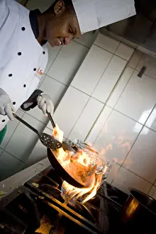 Kigali, Rwanda. A chef prepares lunch at the Bourbon Coffee shop. (MR)