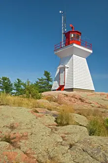 Killarney East Lighthouse on Red Rock Point of Georgian Bay (Lake Huron). Killarney East Lighthouse on Red Rock Point of Georgian Bay (Lake Huron). Precambrian shield in winter Killarney, Ontario, Canada