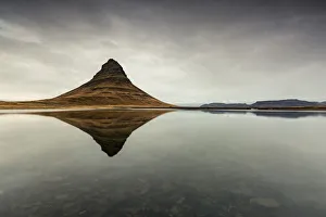 Kirkjufell Mountain reflects itself on the Atlantic waters in Snaefellsnes peninsula Kirkjufell Mountain reflects itself on the Atlantic waters in Snaefellsnes peninsula