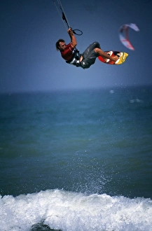Kite Prints: A kitesurfer makes a large tailgrab jump off Masirah