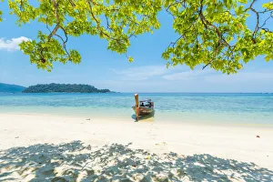 Ko Lipe, Satun Province, Thailand. Traditional long tail boat moored on an empty beach