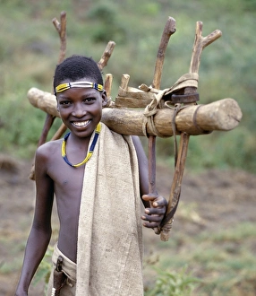 Images Dated 5th February 2009: A Konso youth of southwest Ethiopia carries home a
