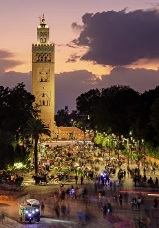 Crowds Prints: Koutoubia Minaret at dusk with crowds of people walking, Marrakech, Morocco