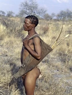 African Tribe Gallery: A !Kung hunter-gatherer stands ready to accompany his