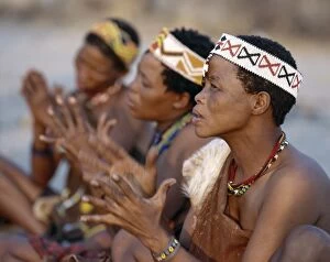 African Tribe Gallery: !Kung women sing and clap their hands to the rhythm of their menfolk