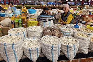 Kyrgyzstan, Bishkek, Osh bazaar, a local woman sells cheese balls