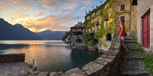 Steps Prints: A lady observes sunset at Nesso, Como lake, Como, Lombardy, Italy (MR)