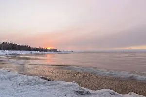 Frigid Prints: Lake Michigan shoreline with winter snow squall at dawn, Manistique, Michigan, USA