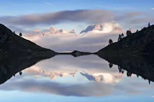Symmetry Prints: Lake Ritorto and Brenta Dolomites peaks at sunset, Madonna di Campiglio, Trento province