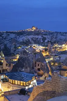 Kapadokya Prints: Landscape of the ancient town of Goreme at duskwith Uchisar fortrees in the background