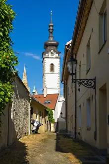 Alley Prints: Lane towards tower of Church of the Nativity of the Blessed Virgin Mary on sunny day