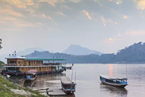 Laos, Luang Prabang, Riverboats on the Mekong River, sunset