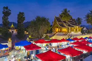 Images Dated 3rd February 2018: Laos, Luang Prabang, Sisavangvong Road, Handicraft Night Market and Wat Ho Pha Bang