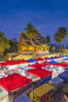 Images Dated 3rd February 2018: Laos, Luang Prabang, Sisavangvong Road, Handicraft Night Market and Wat Ho Pha Bang