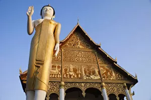 Images Dated 6th March 2012: Laos, Vientiane, Pha That Luang, Buddha Statue at Sunrise
