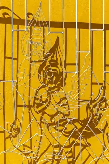 Laotian Prints: Laos, Vientiane, Wat Si Muang, window gates with Buddha figure