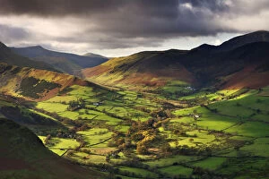 Late afternoon sunshine illuminates the lush green Newlands Valley, Lake District