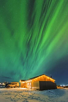 Laugarvatn, Iceland. Northern lights over typical Icelandic houses in winter