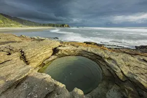 Limestone Prints: Layered limestone circular rock pool on the coast at Punakaiki in Paparoa National Park