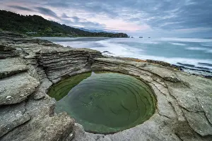 Limestone Prints: Layered limestone circular rock pool on the coast at Punakaiki in Paparoa National Park