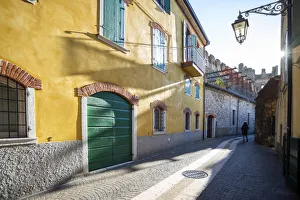 Garda Lake Prints: Lazise sul Garda, Verona province, Veneto, Italy A woman walking in the old town centre