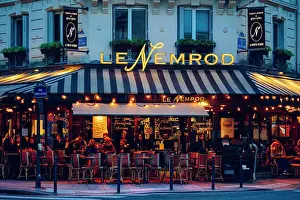 Customers Prints: Le Nemrod illuminated after sunset. Typical Cafe Restaurant in Paris, France