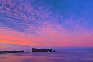 Le Rocher Perce or Perce Rock in the Atlantic Ocean at sunset Perce, Quebec, Canada