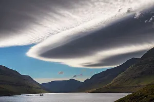 Wind Prints: Lenticular clouds hovering over a fjord in the island of Vidoy