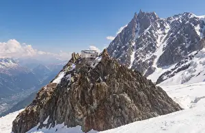 Les Grand Mulets alpine refuge over a rock in Mount Blanc north side over glacier