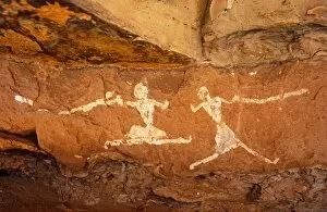 Rock Art Gallery: Libya, Fezzan, Jebel Akakus. A pair of running figures painted onto the walls of Uan Muhuggiag
