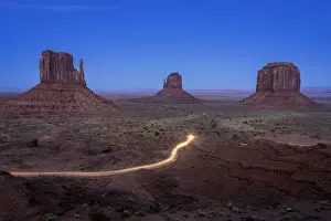 Merrick Butte Prints: Light trail from car driving on scenic drive road near The Mitten Buttes in Monument