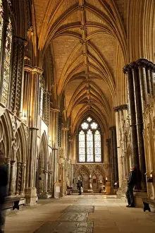Midlands Prints: Lincoln, England. A visitor gazes at the medieval stone work in Lincoln cathedral