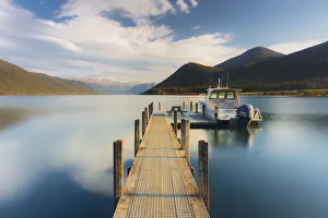 A little boat and a jetty in the Rotoroa lake, part of the Nelson lakes in New Zealand