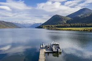 A little boat and a jetty in the Rotoroa lake, part of the Nelson lakes in New Zealand