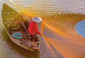 Hoi An Prints: Local fisherman checking his net, Cua Dai village, near Hoi An, Central Vietnam, Asia