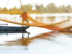 Hoi An Prints: Local fisherman checking his net, Cua Dai village, near Hoi An, Central Vietnam, Asia