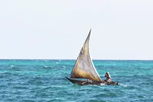 Zanzibar Prints: Local fisherman on a small traditional dhow heading out to sea, Nungwi, Zanzibar, Tanzania