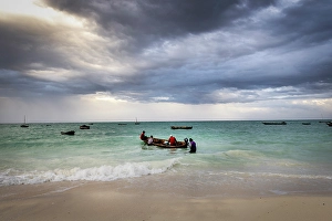 Local Fishermen Prints: Local fishermen heading out to sea on an open wooden boat, Nungwi, Zanzibar, Tanzania