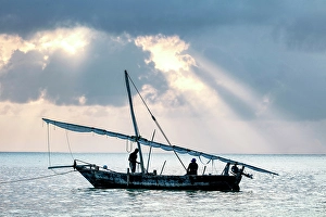 Zanzibar Prints: Two local fishermen on their traditional dhow at sunrise, Jambiani, Zanzibar, Tanzania