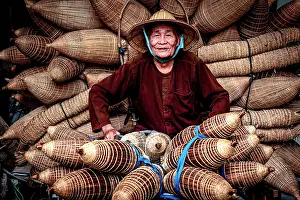 Craft Prints: Local man sitting among handmade fish traps, Hanoi, Vietnam. (MR)