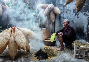 Local man with traditional bamboo fish traps, Thu Sy Village, near Hanoi, Vietnam